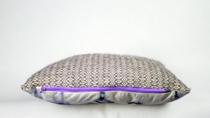 side view of handwoven pillow with zipper